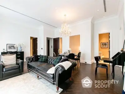 Elegant living room with polished hardwood floors, luxurious leather sofa, grand piano, and exquisite chandelier, perfect for sophisticated living.