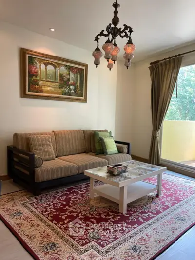 Elegant living room with classic chandelier and cozy sofa near a bright window.