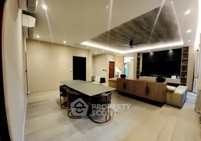 Luxurious modern living room with elegant dining area and stylish ceiling design.