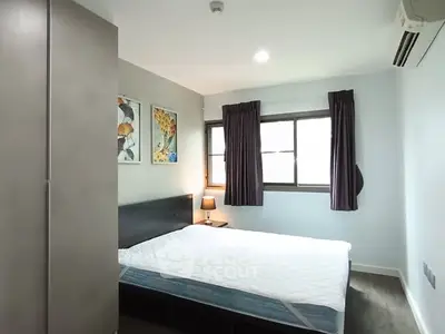 Cozy bedroom with modern decor and ample natural light