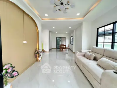 Spacious modern living room with elegant lighting and cozy seating area