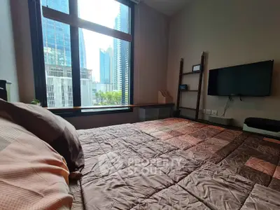 Modern bedroom with city view, featuring a cozy bed and wall-mounted TV, perfect for urban living.