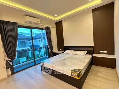 Spacious modern bedroom with balcony view in stylish home