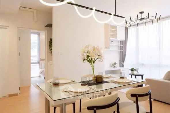Modern dining area with elegant lighting and stylish decor in a bright apartment.