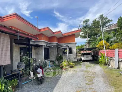 Charming single-story home with driveway and lush garden in a serene neighborhood.