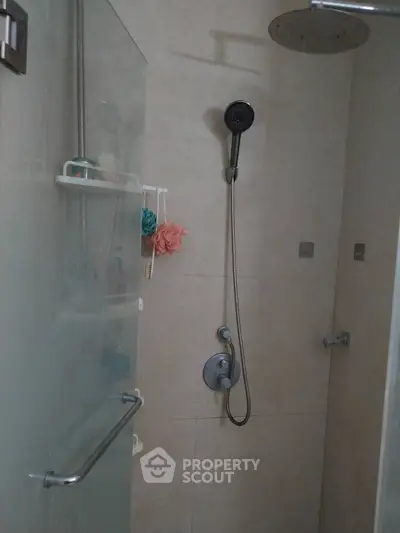 Modern bathroom shower area with sleek fixtures and glass door