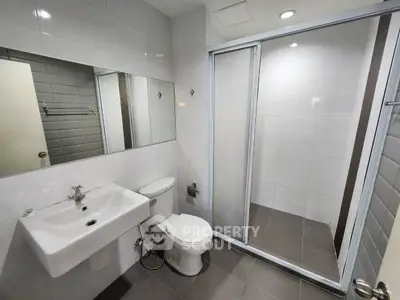 Modern bathroom with sleek fixtures and spacious shower area