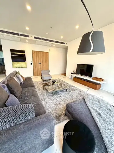 Luxurious modern living room with plush gray sofa and stylish decor