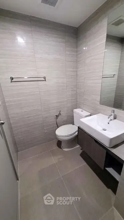 Modern bathroom with sleek fixtures and neutral tiles