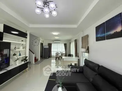 Spacious modern living room with sleek black furniture and elegant lighting