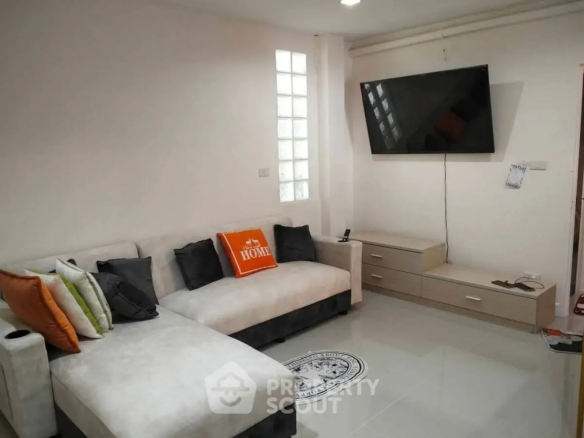 Modern living room with stylish sofa and wall-mounted TV