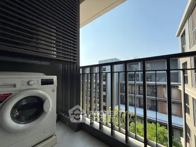 Modern apartment balcony with washing machine and city view