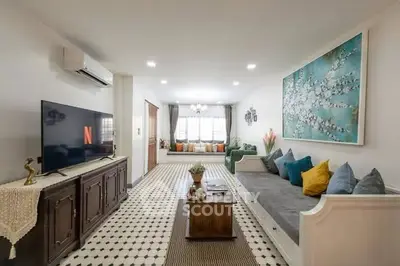 Spacious living room with modern decor and large windows for natural light.