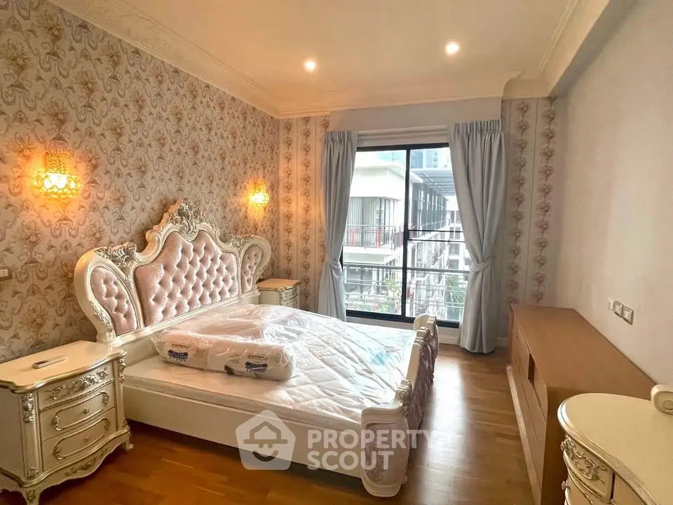 Luxurious bedroom with elegant decor and large window offering city view