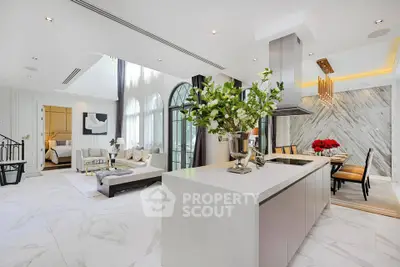 Luxurious open-plan living room and kitchen with elegant decor and high ceilings