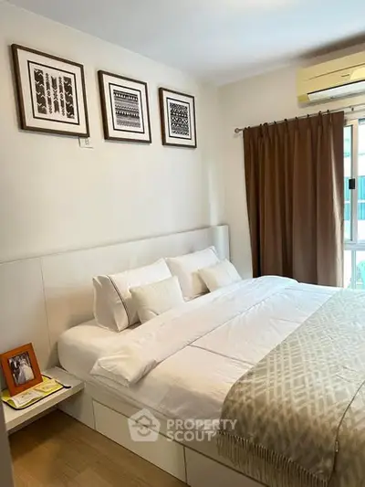 Cozy bedroom with modern decor and large window for natural light