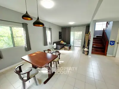 Spacious living room with modern dining area and natural light