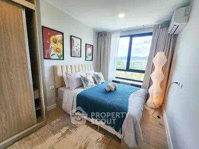 Modern bedroom with stylish decor and scenic window view