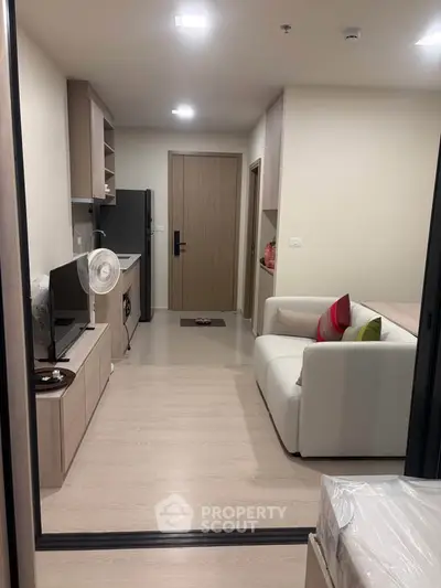 Modern apartment interior with cozy living room and compact kitchen