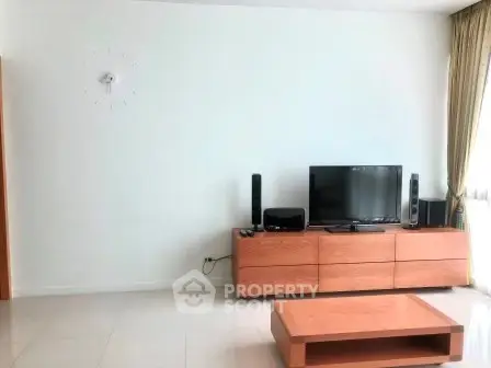 Modern living room with sleek wooden furniture and entertainment setup