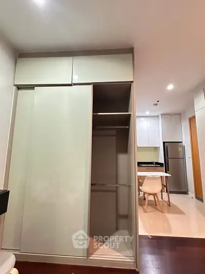 Modern apartment interior with open kitchen and built-in storage