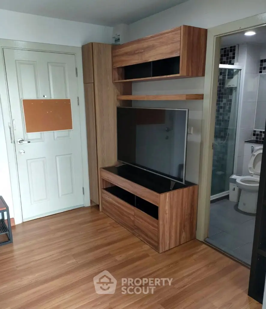 Modern living room with wooden TV cabinet and bathroom view
