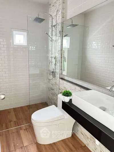 Modern bathroom with glass shower and sleek fixtures