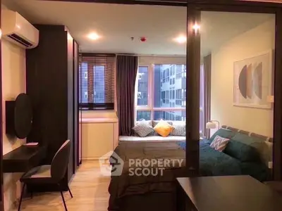 Modern bedroom with stylish decor and large window offering city view, perfect for urban living.