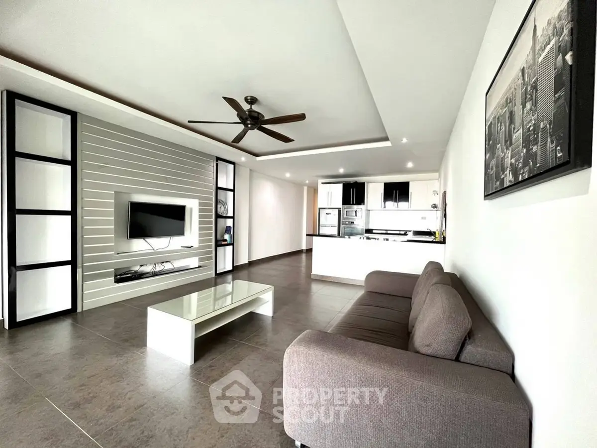 Spacious modern living room with open kitchen and sleek design