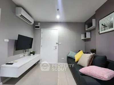 Modern living room with sleek design, featuring a comfortable sofa, wall-mounted TV, and stylish decor.