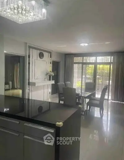 Elegant open-plan living and dining area with modern decor and large windows for natural light.