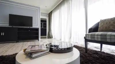 Elegant living room with modern decor and large windows for natural light.