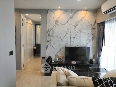 Modern living room with marble accent wall and sleek TV setup