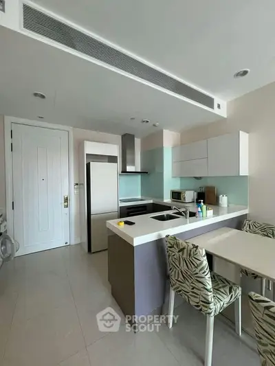 Modern kitchen with sleek design, featuring an open layout and contemporary appliances.