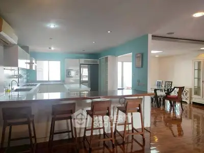 Spacious open-layout kitchen with modern appliances and stylish dining area