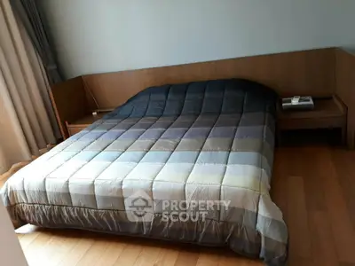 Cozy bedroom with wooden flooring and modern bed design