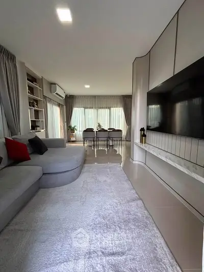 Luxurious living room with modern decor, spacious seating, and elegant dining area, perfect for entertaining.