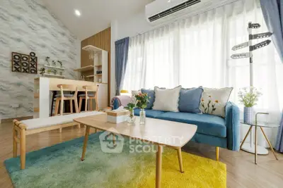 Stylish living room with modern decor and open kitchen layout