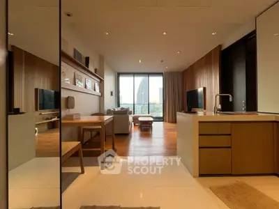 Modern open-layout living room with kitchen and city view, featuring sleek wooden finishes and natural light.