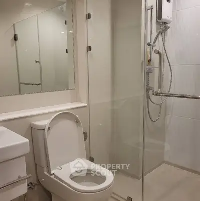 Modern bathroom with glass shower enclosure and sleek fixtures