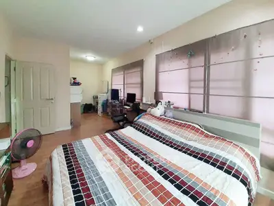 Spacious bedroom with modern decor and ample natural light