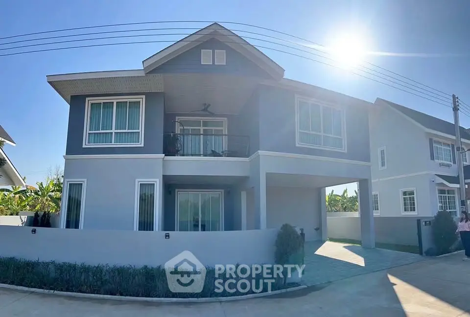 Modern two-story house with large windows and a sunny exterior, perfect for family living.