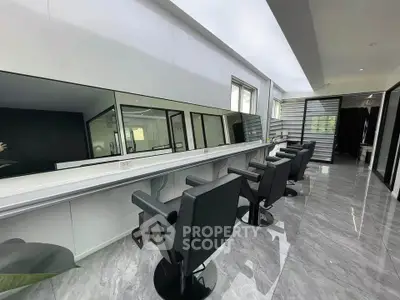 Modern salon interior with sleek design and stylish chairs, perfect for a luxury beauty experience.
