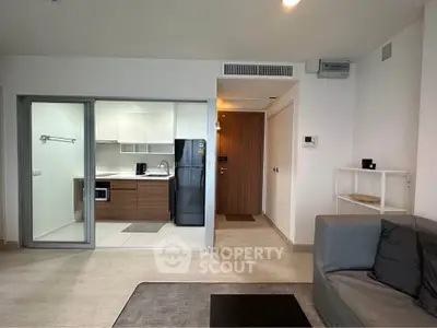 Modern open-plan living room with sleek kitchen and stylish decor