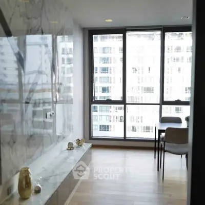 Modern apartment with floor-to-ceiling windows and elegant marble accents.