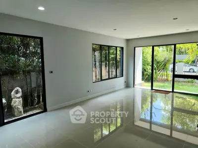 Spacious modern living room with large windows and garden view