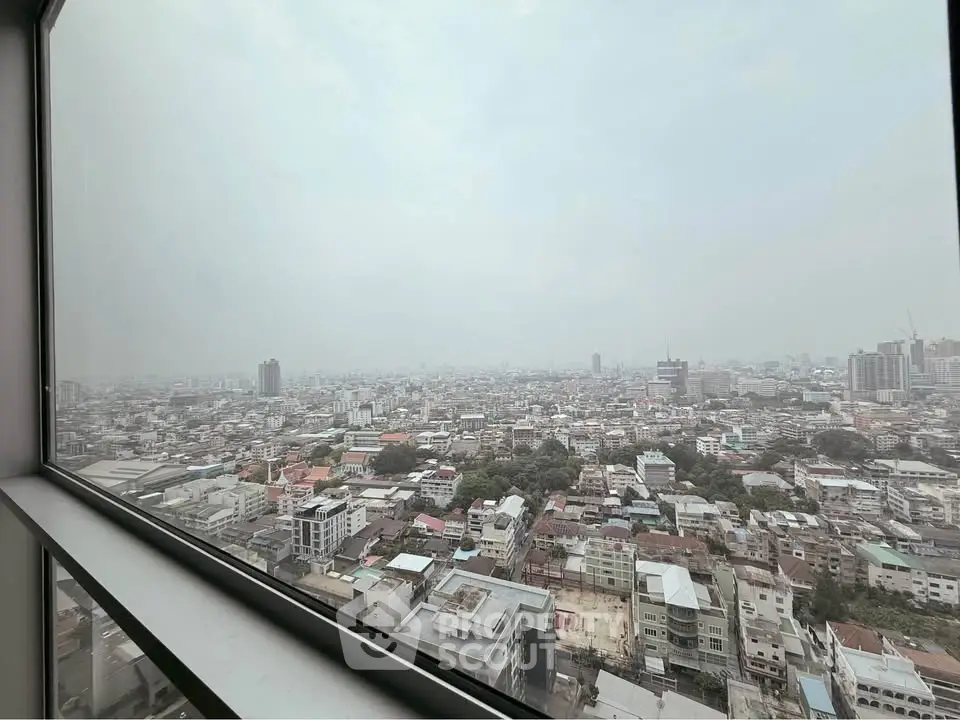 Stunning panoramic city view from high-rise building window, showcasing urban landscape and skyline.