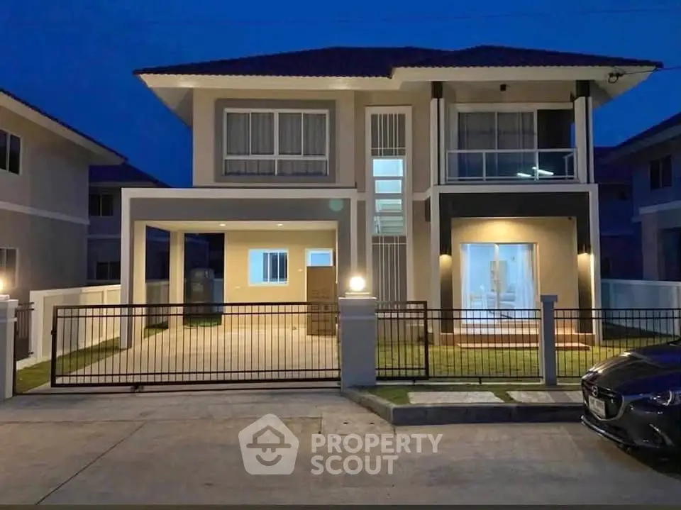 Modern two-story house with spacious driveway and elegant facade at dusk.