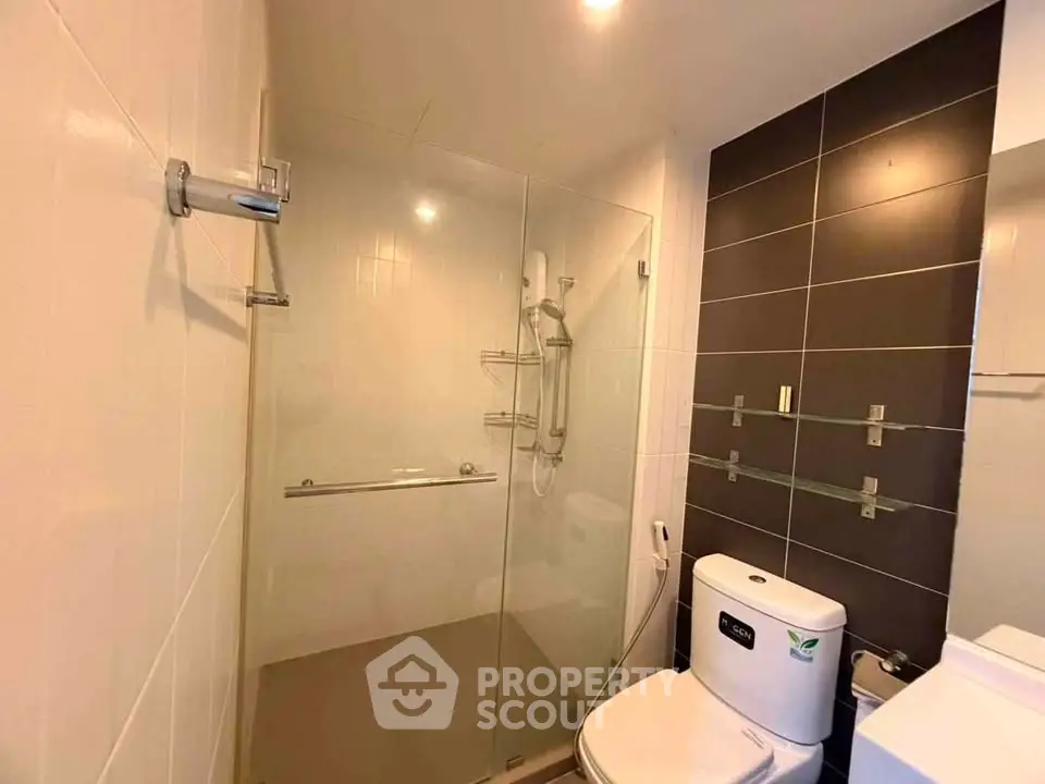 Modern bathroom with glass shower enclosure and sleek tile design