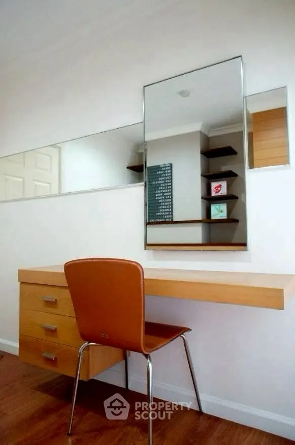 Modern study area with sleek desk and mirror in contemporary home.